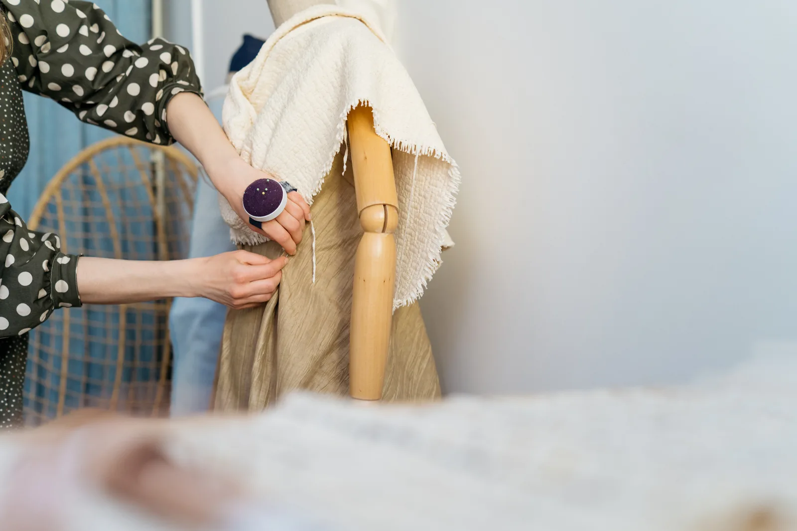 A clothing brand founder steaming and photographing a new garment from the latest collection before launch