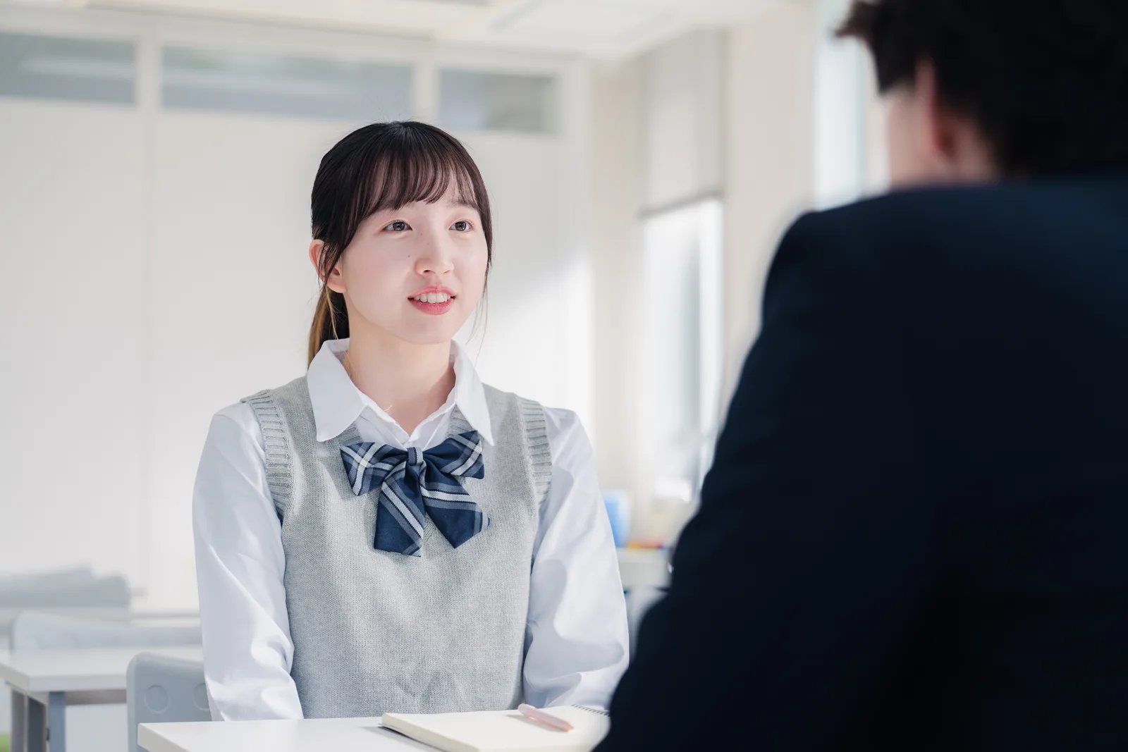 Admissions consultant and a high school student reviewing her college application plan across a desk