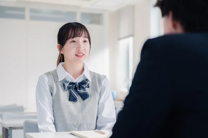 Counselor advising a high school student about college applications