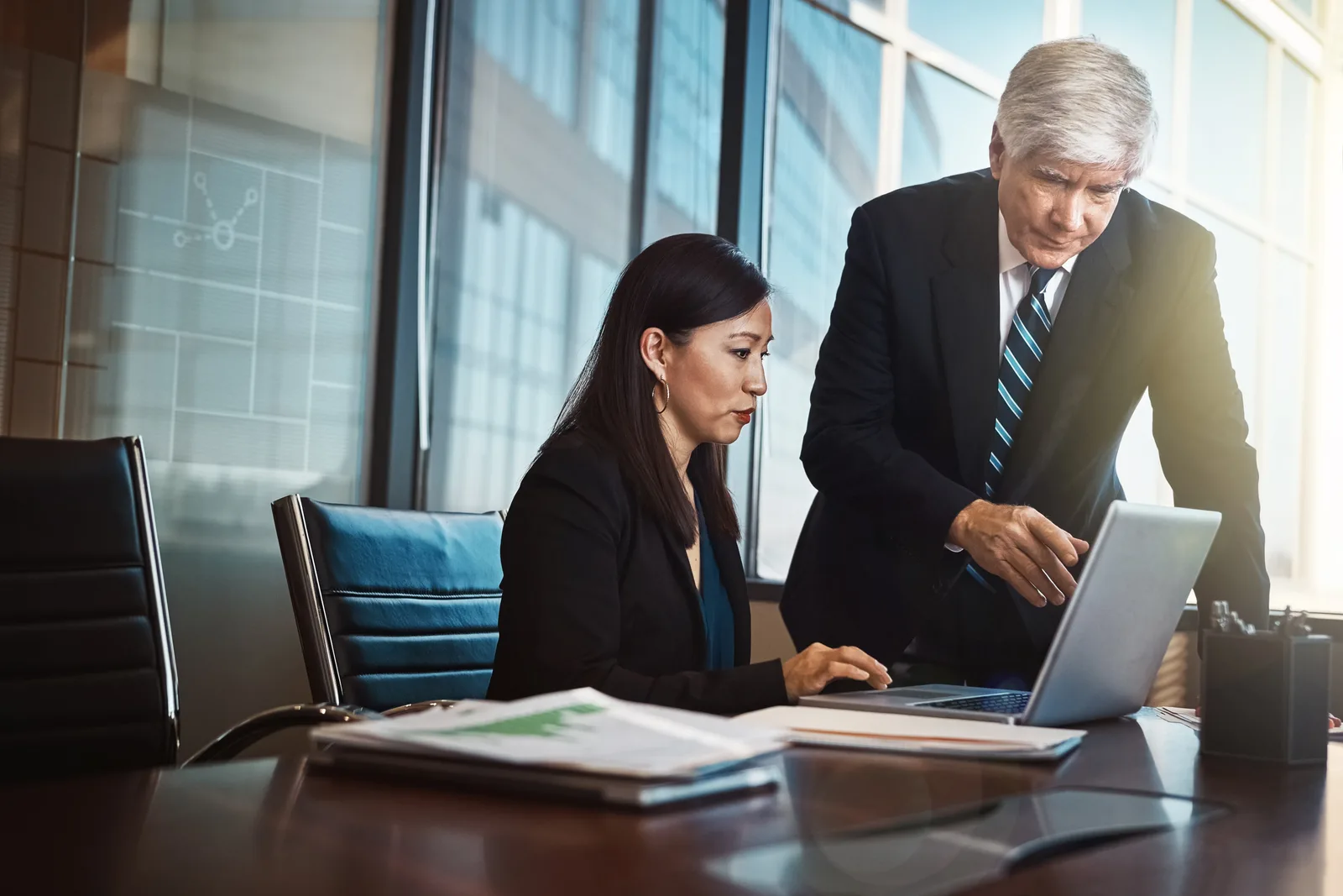 Commercial real estate asset manager and broker reviewing leasing and portfolio data together on a CRE software dashboard