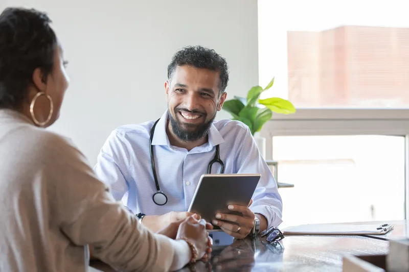 Plastic surgeon consulting with a patient during an appointment in a clinic