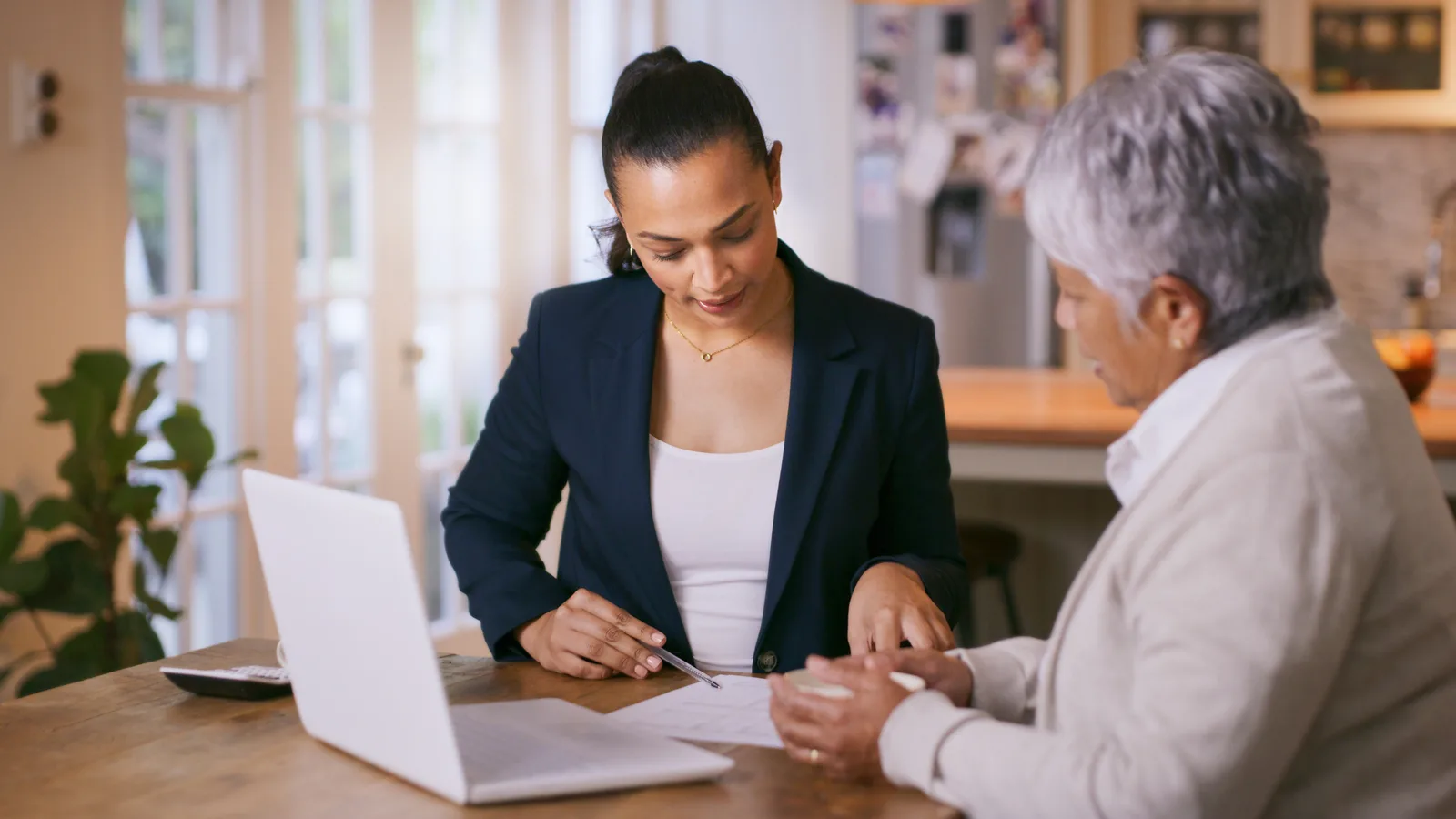 Credit repair specialist pointing out disputed items on a client's credit report during a free consultation