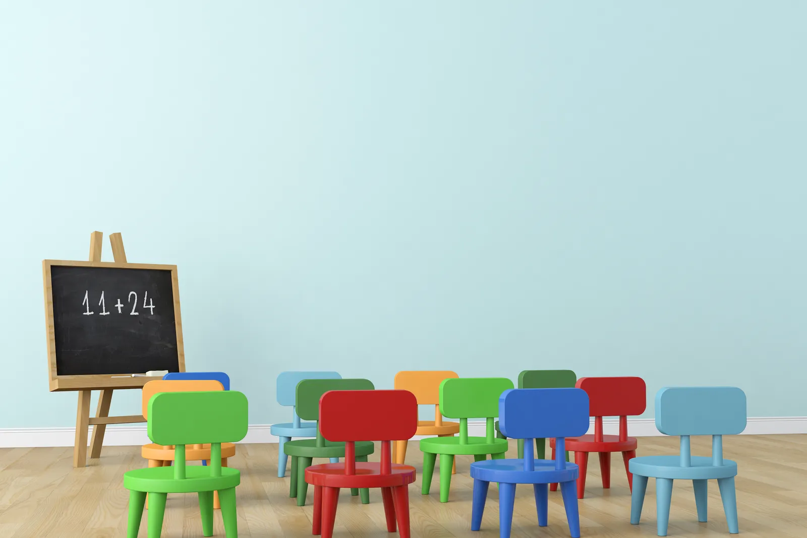 Empty daycare classroom with small chairs, cubby storage, and toys arranged along the wall