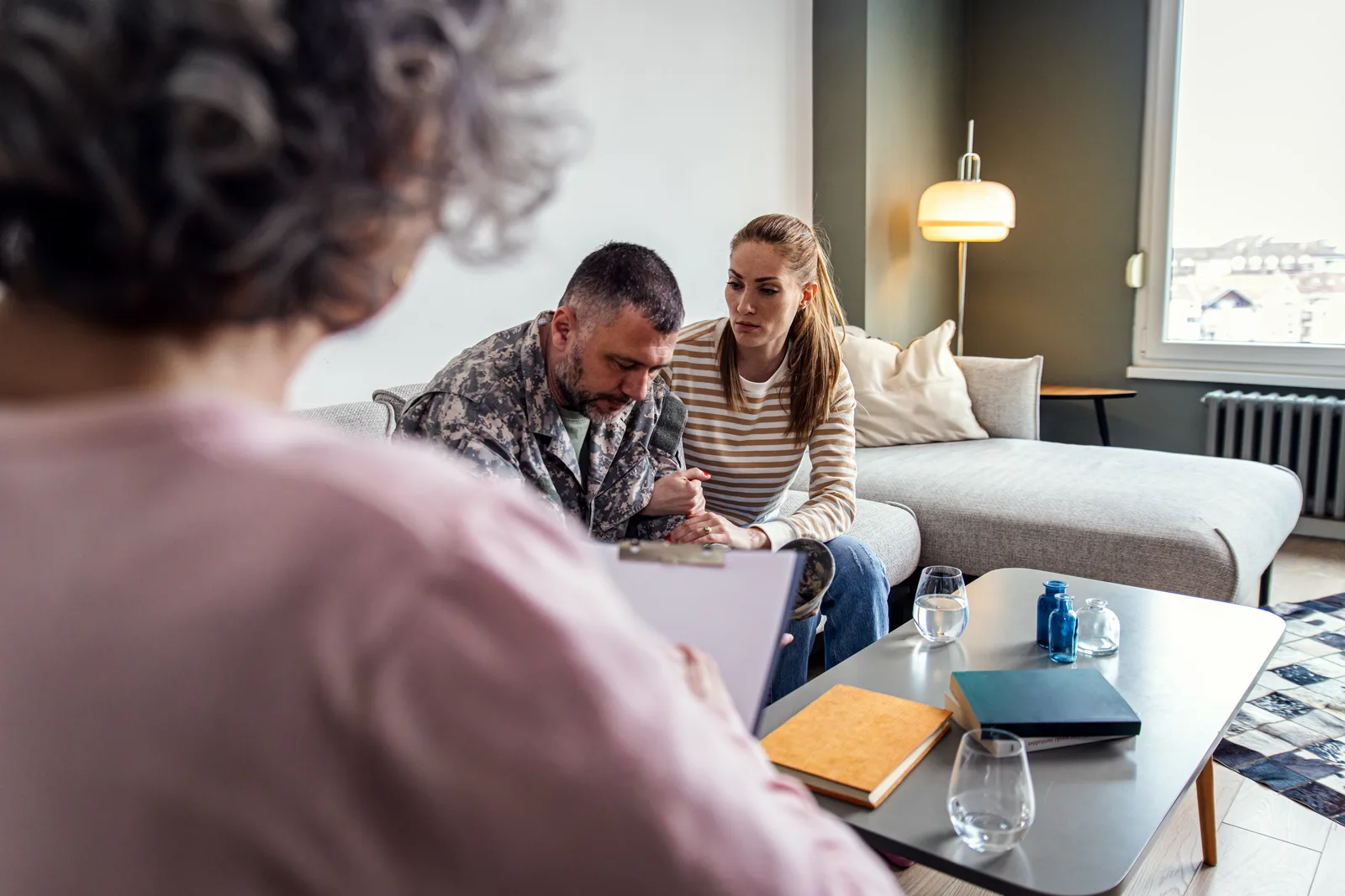 Deportation defense attorney reviewing an immigration bond hearing notice with a client's family in her office
