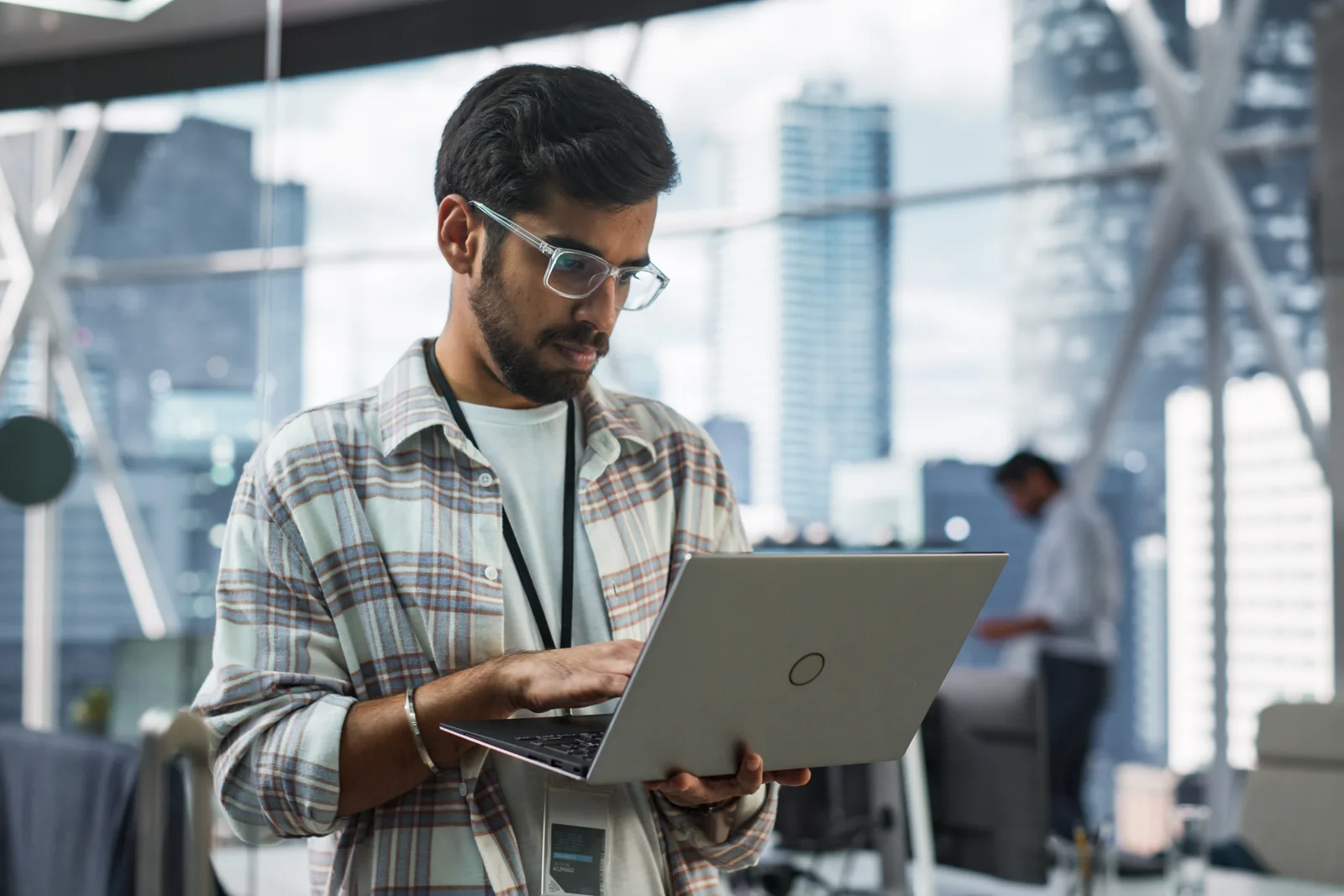 Devtools engineering team reviewing install and activation numbers together at a laptop in their office