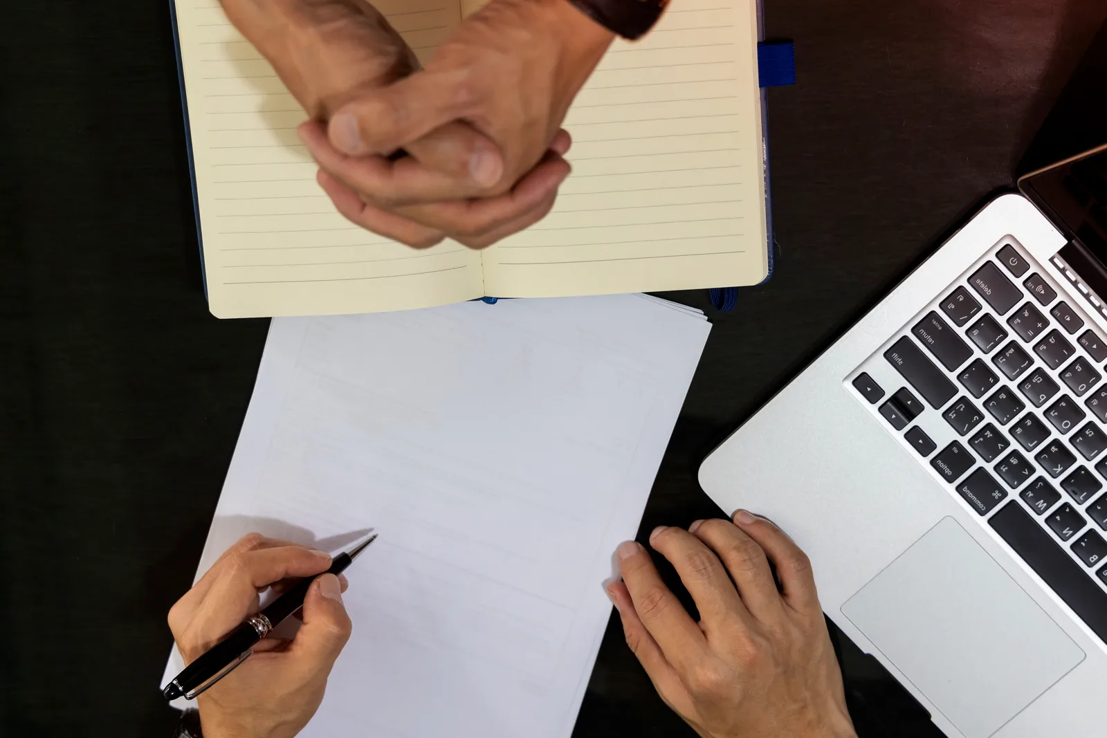 Divorce lawyer meeting with a client across a desk to review the terms of a settlement agreement