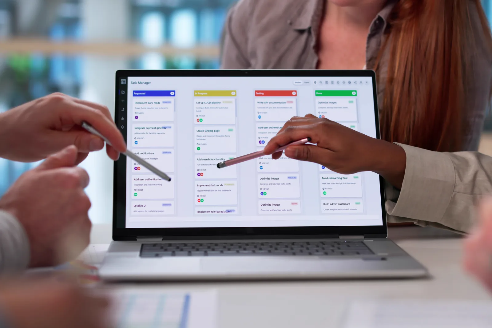 Software team reviewing an online storefront and admin dashboard together on a laptop screen
