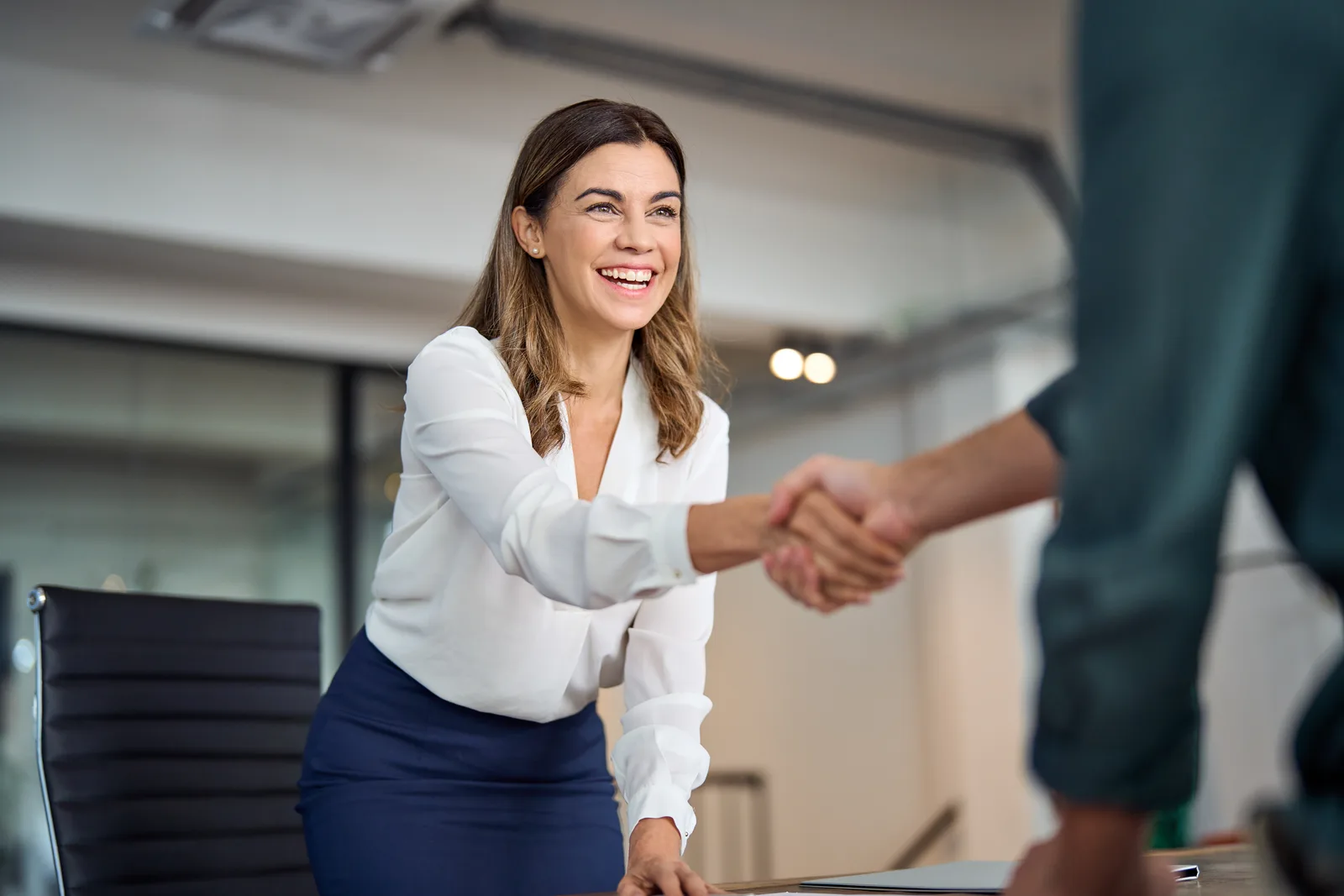 Employment lawyer reviewing a severance agreement with a client at a conference table