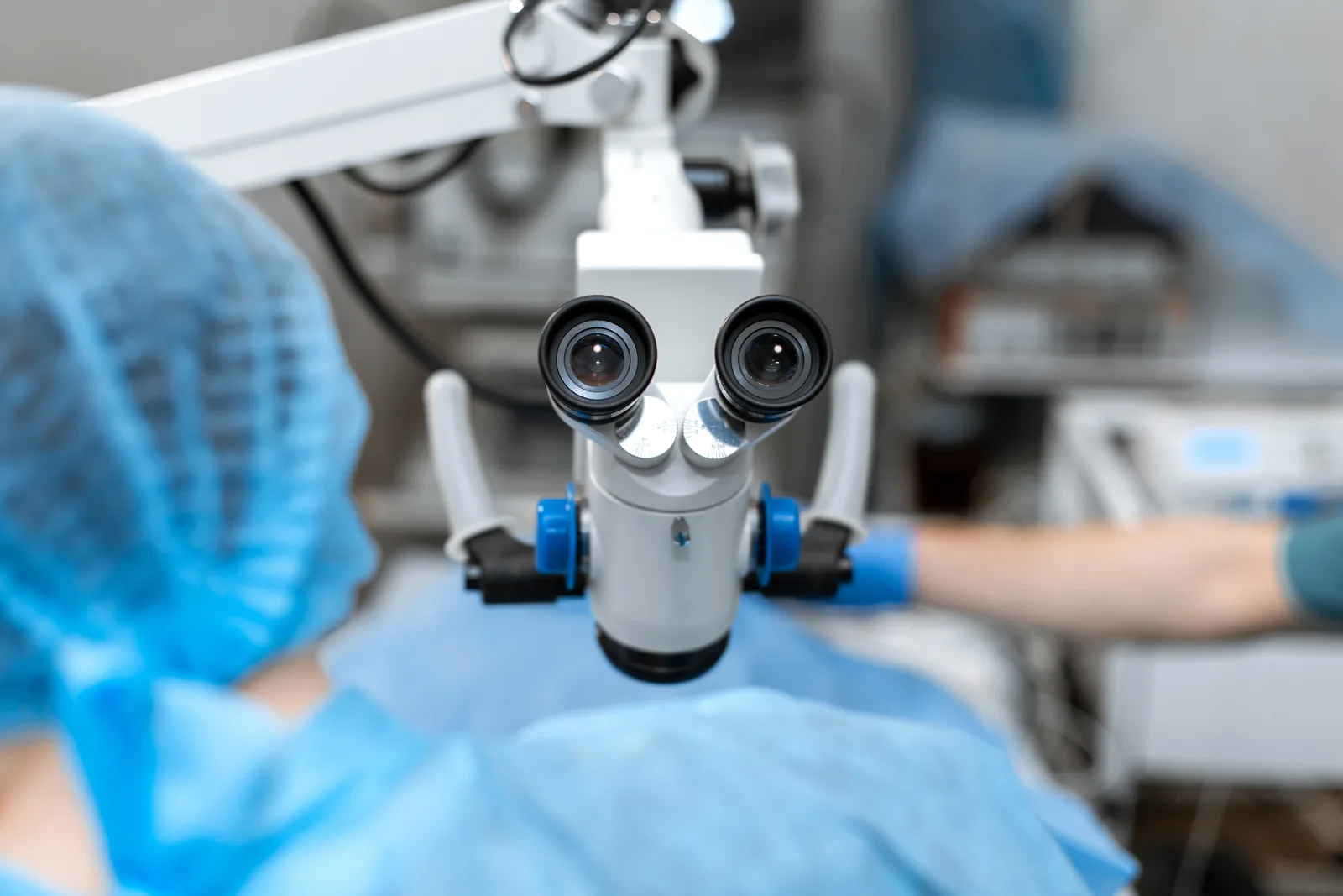 Endodontist using a dental operating microscope to perform a root canal procedure