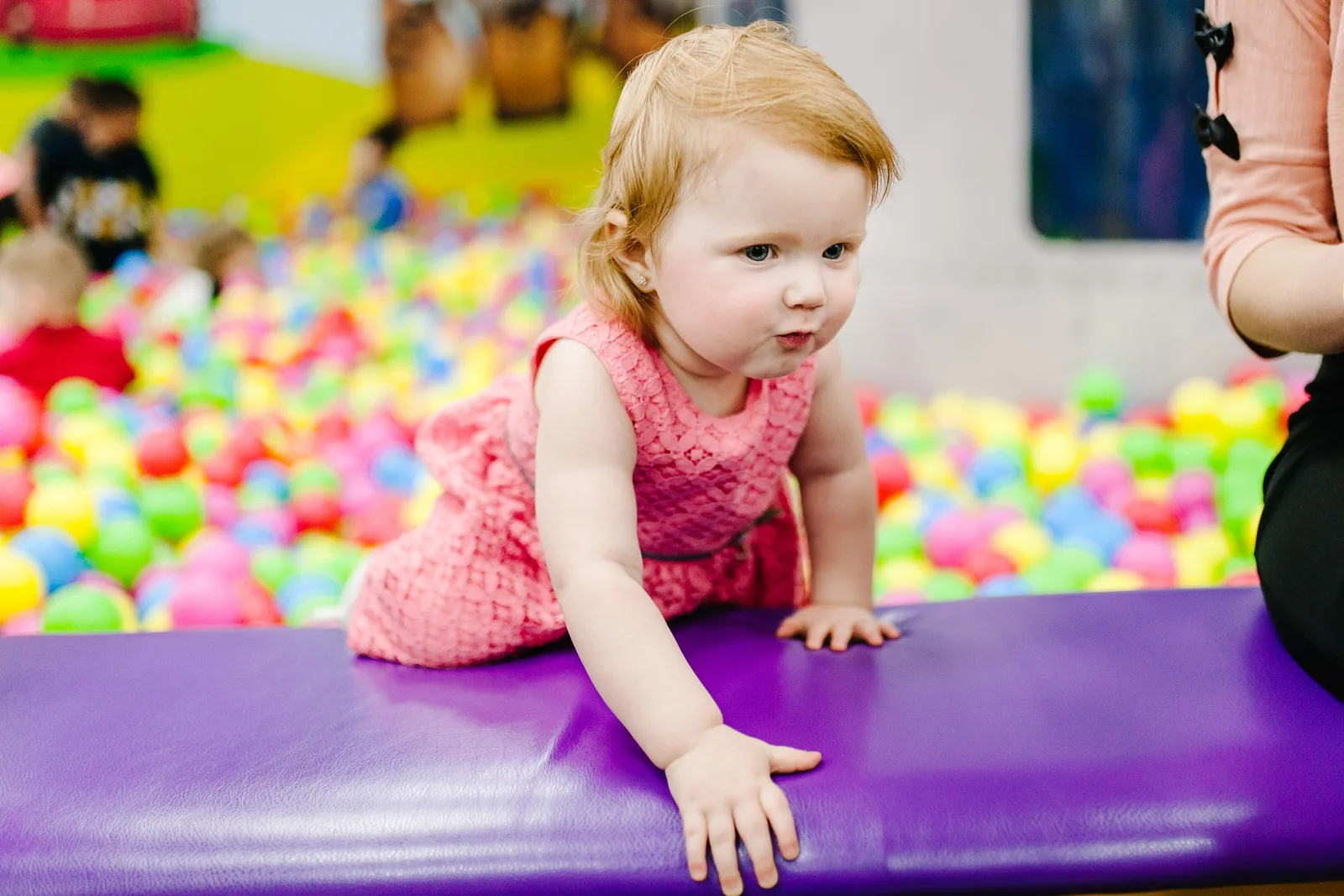 Kids jumping on trampolines during a birthday party at a busy family entertainment center