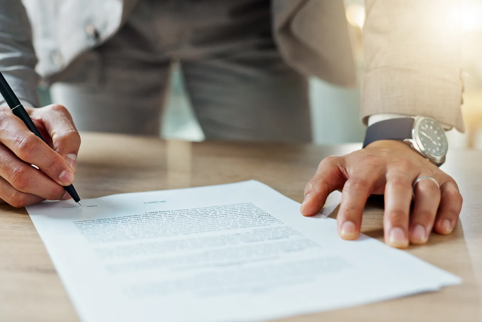 Landlord-tenant attorney reviewing an eviction filing with a property owner in a law office