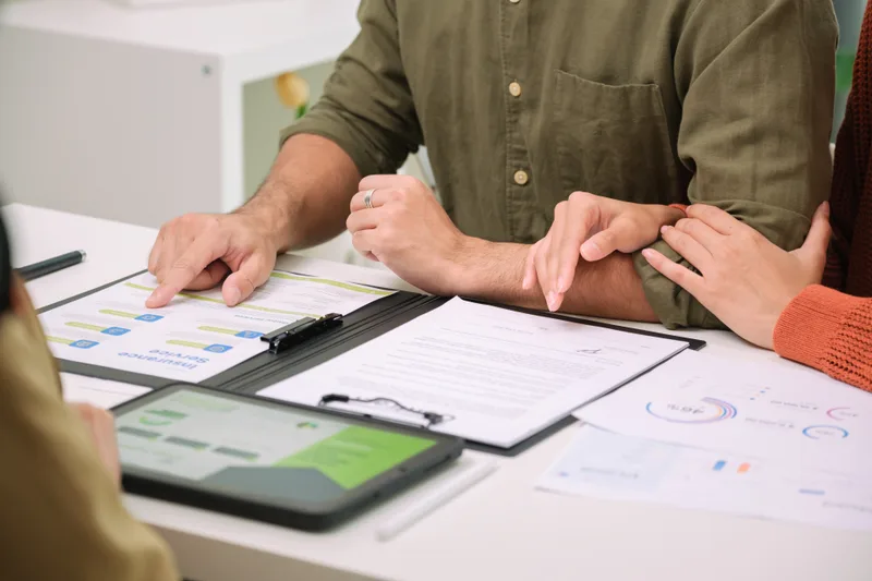 Financial advisor reviewing investment charts with a couple