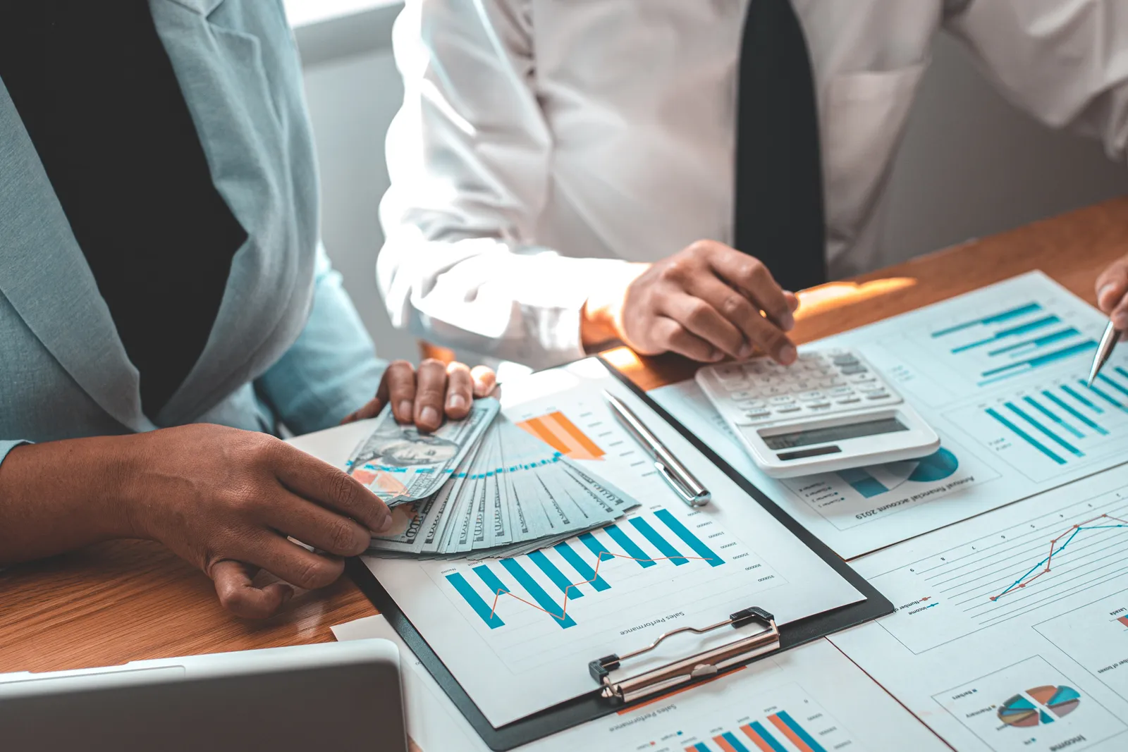 Fractional CFO reviewing a cash-flow forecast and financial dashboard with a startup founder