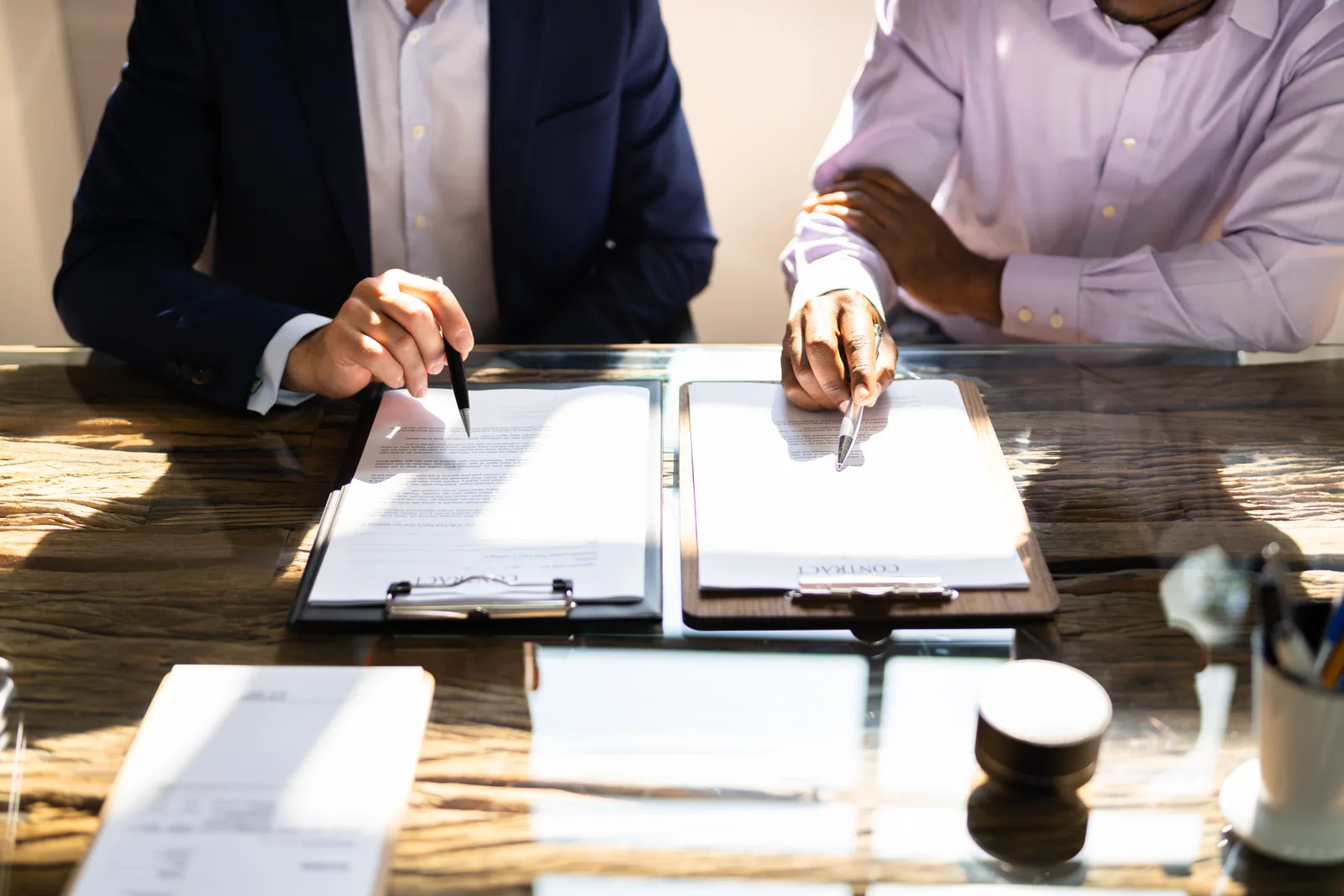 Franchise attorney reviewing a disclosure document with a prospective franchisee at a conference table