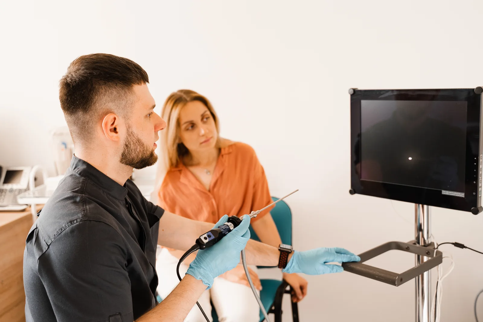 Gastroenterologist reviewing endoscopy imaging with a patient during a consultation