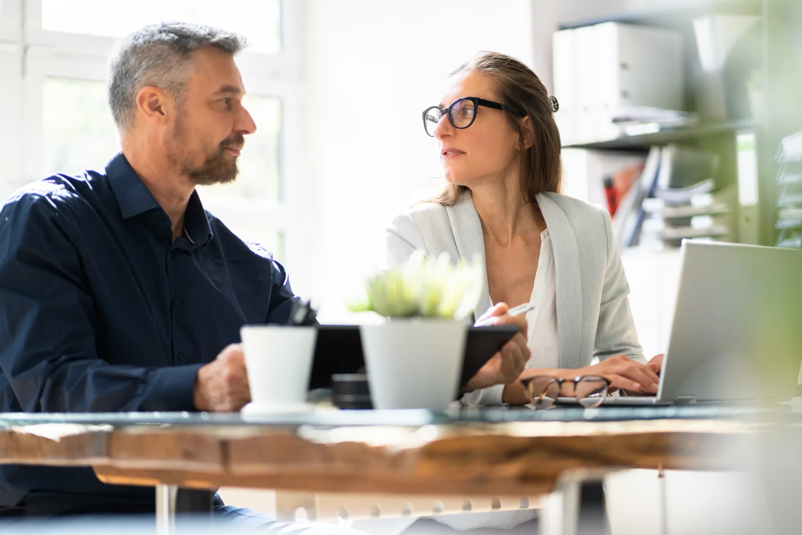 Group benefits broker reviewing employee health and dental plan options with a small business owner