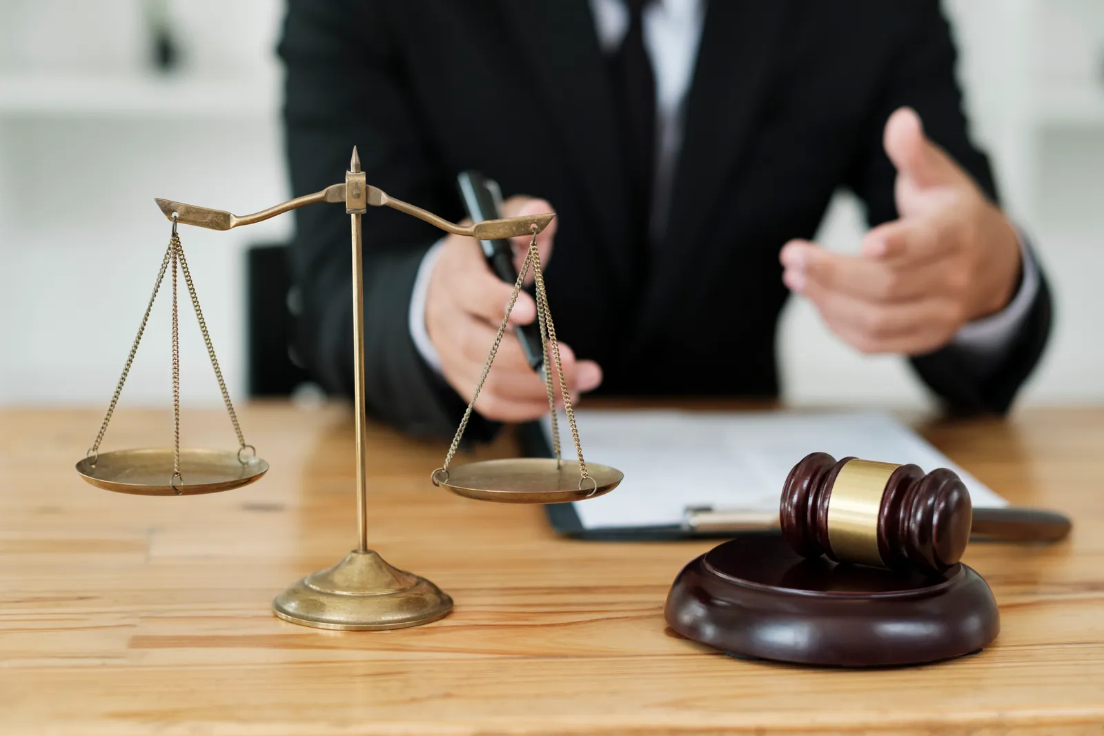 Criminal defense attorney at a desk with the scales of justice and a gavel