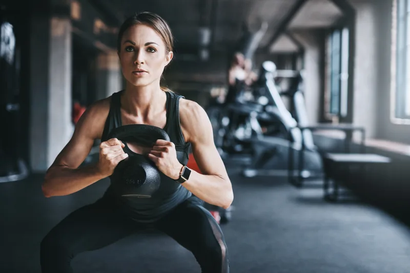 Members training with weights in a modern fitness gym