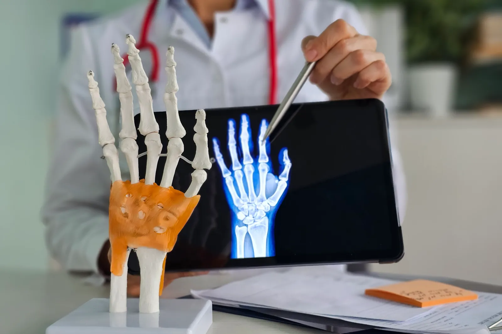 Hand surgeon examining a patient's wrist and fingers during a consultation