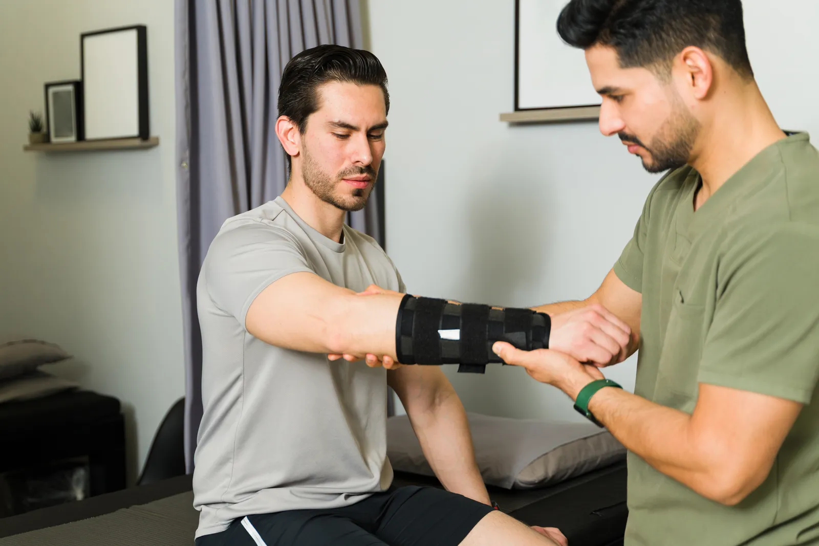 Certified hand therapist fitting a custom splint on a patient's wrist during a therapy session