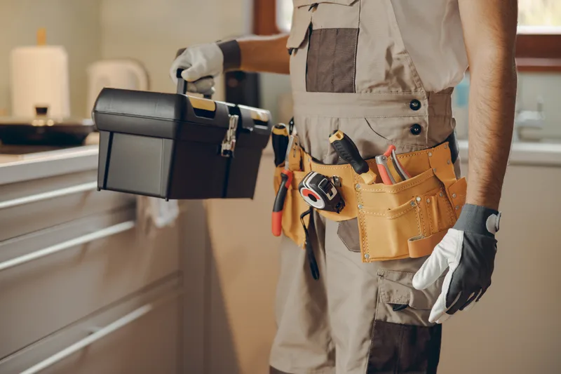 Handyman with a tool bag in a home