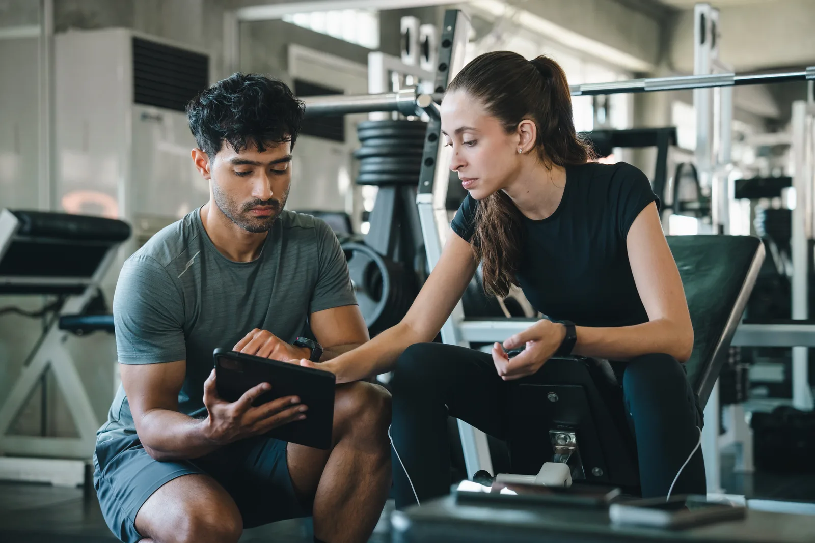 A health coach walking a client through a habit-tracking plan during a video coaching call