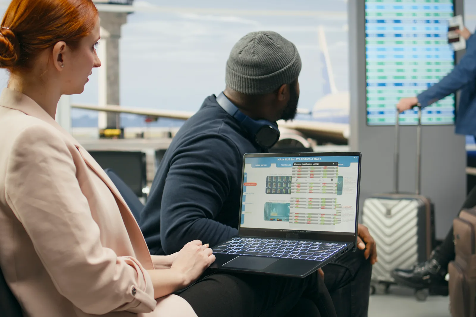 Customer support team reviewing a shared ticket queue and response-time dashboard together at a laptop in their office