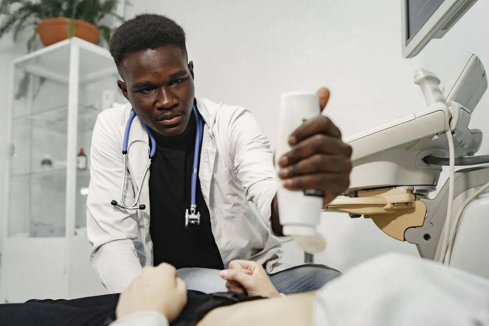 Hepatologist reviewing liver ultrasound imaging with a patient during a consultation