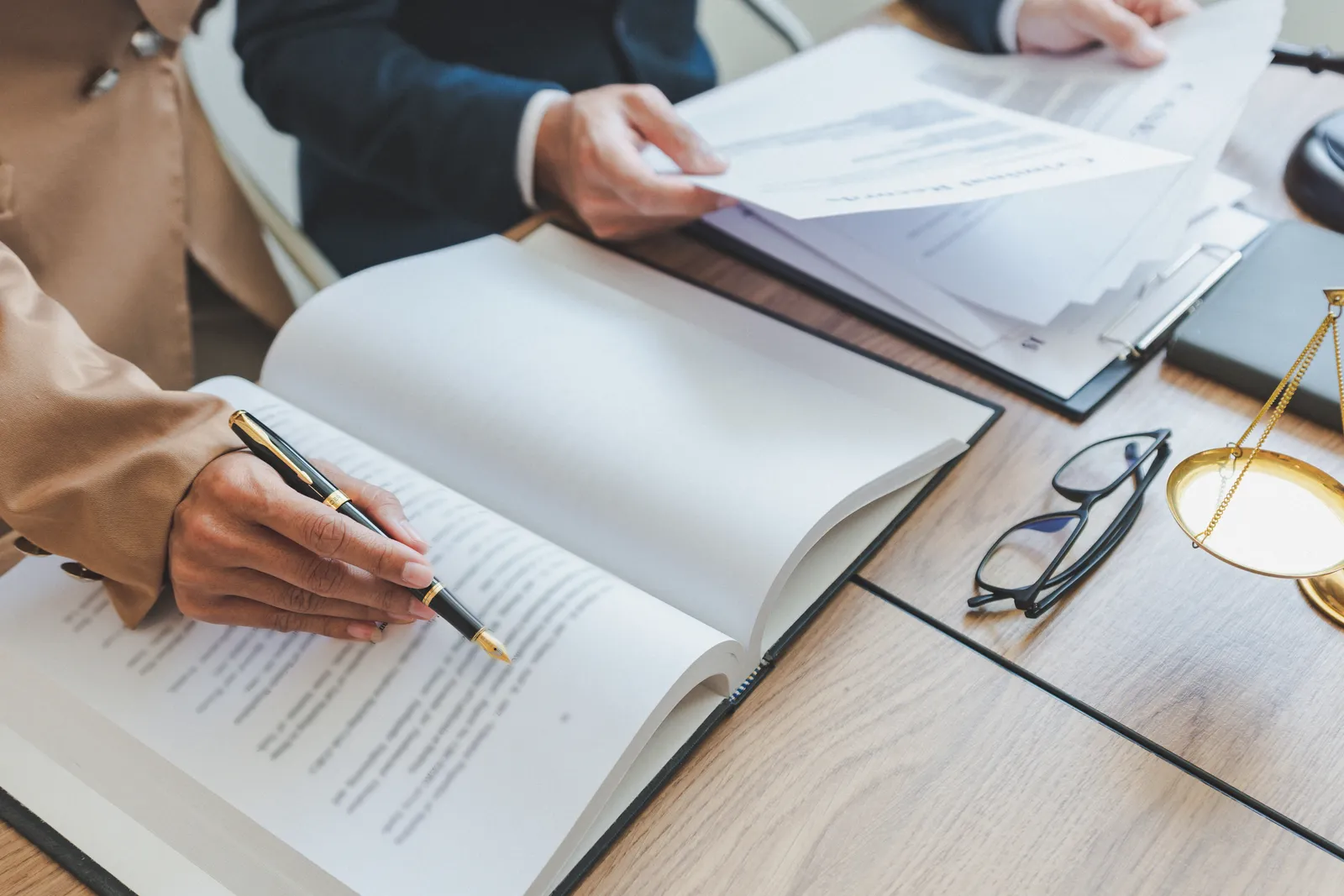 Divorce attorney and client reviewing business valuation and financial statements at a conference table