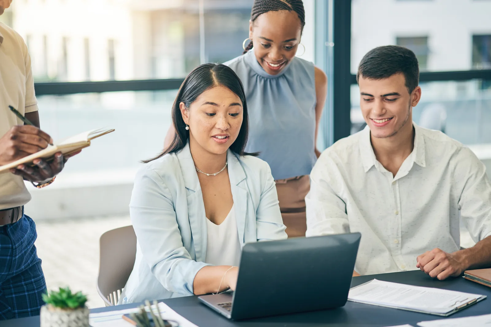 Higher ed admissions CRM software team reviewing an enrollment funnel dashboard together on a laptop in their office