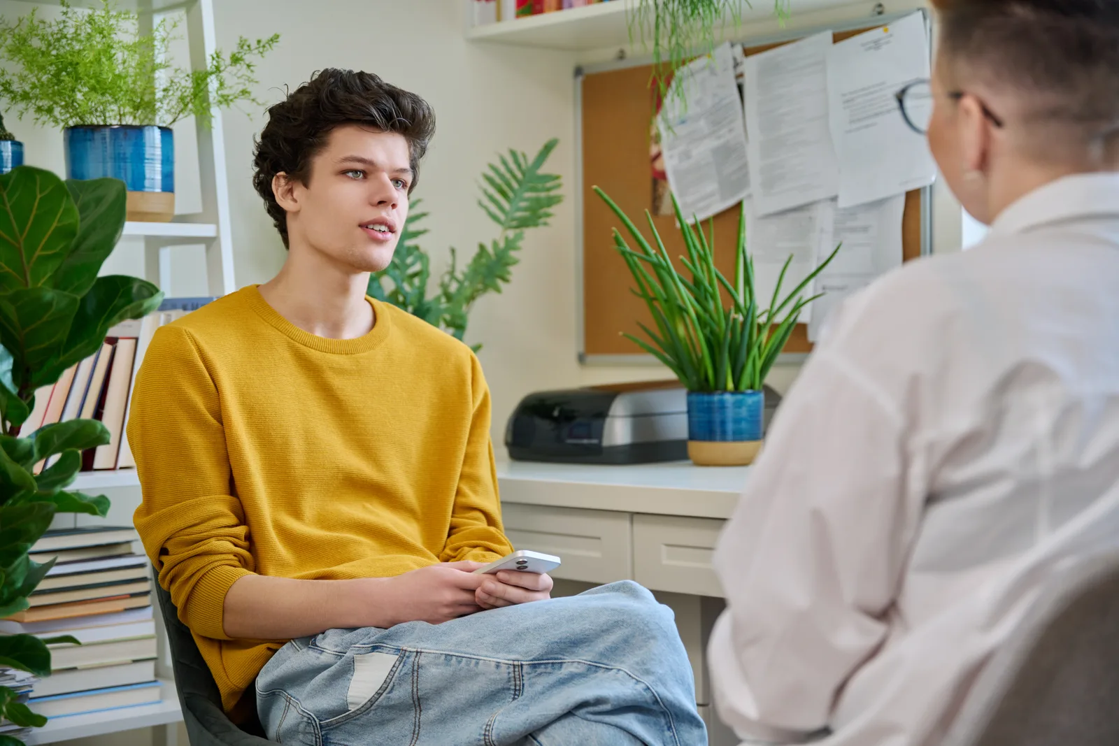 A prospective student and admissions counselor reviewing program options together at a university admissions office