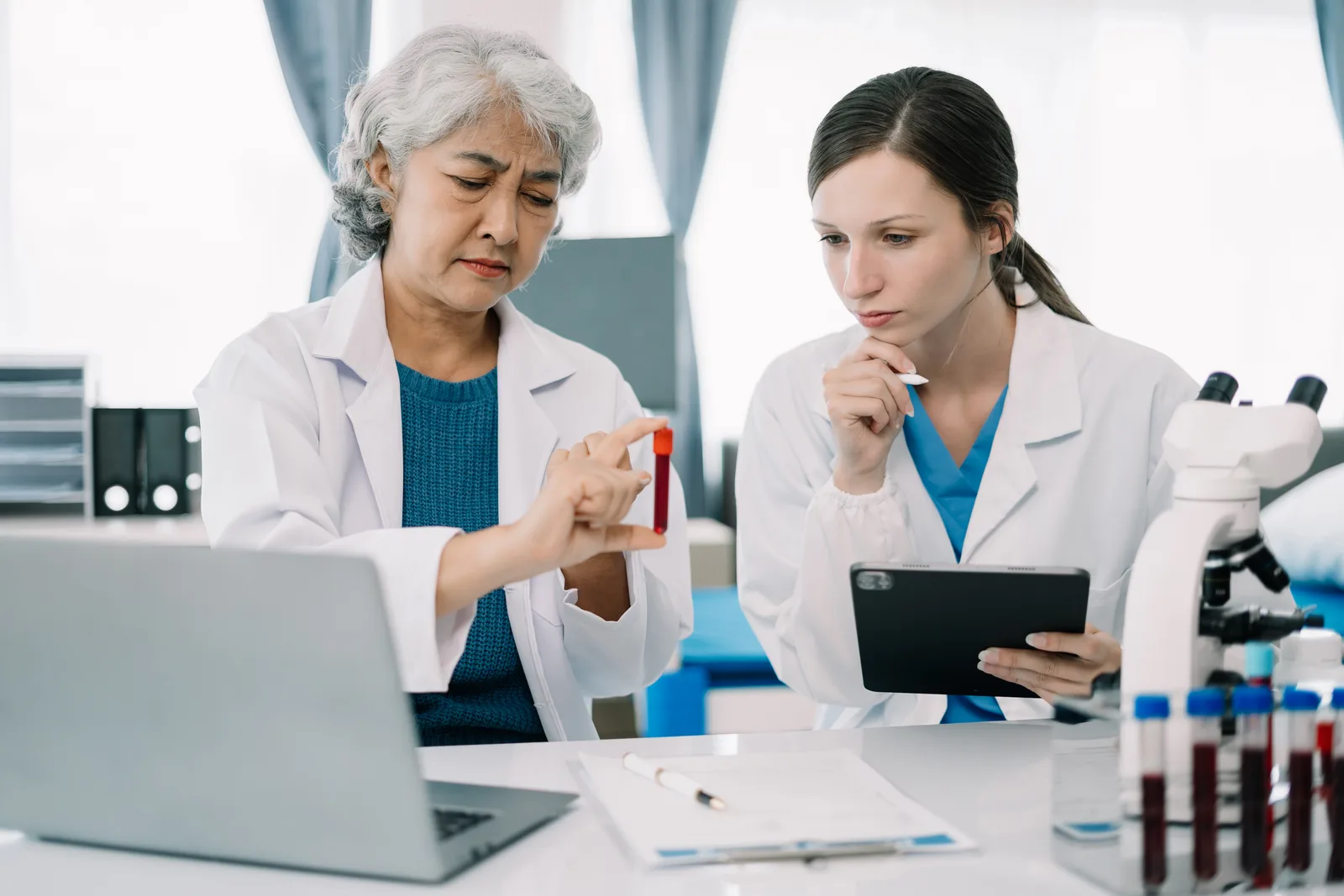 Physician reviewing bloodwork results with a patient during a hormone therapy consultation