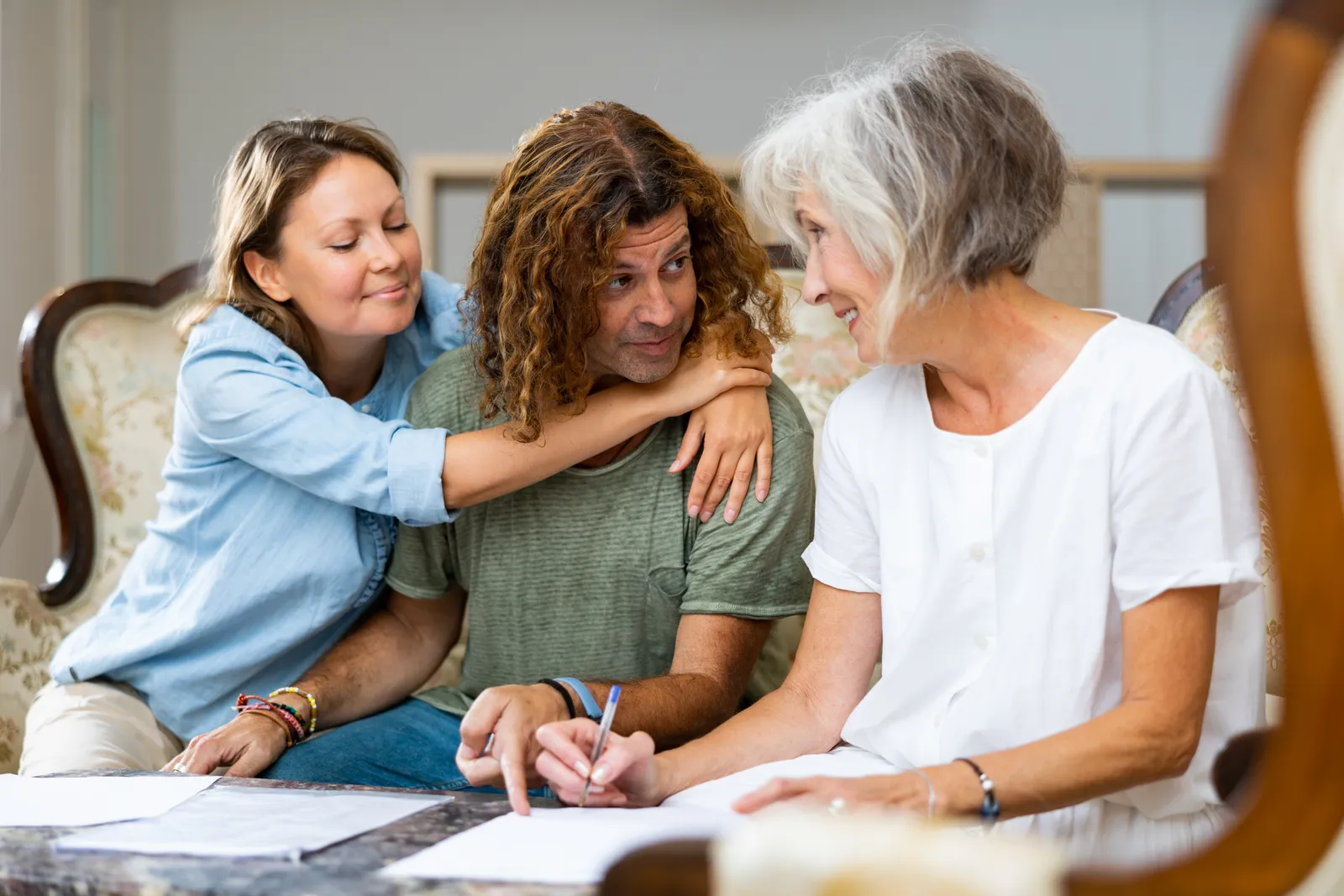 Immigration bond attorney reviewing a client's bond hearing paperwork with the client's family in her office