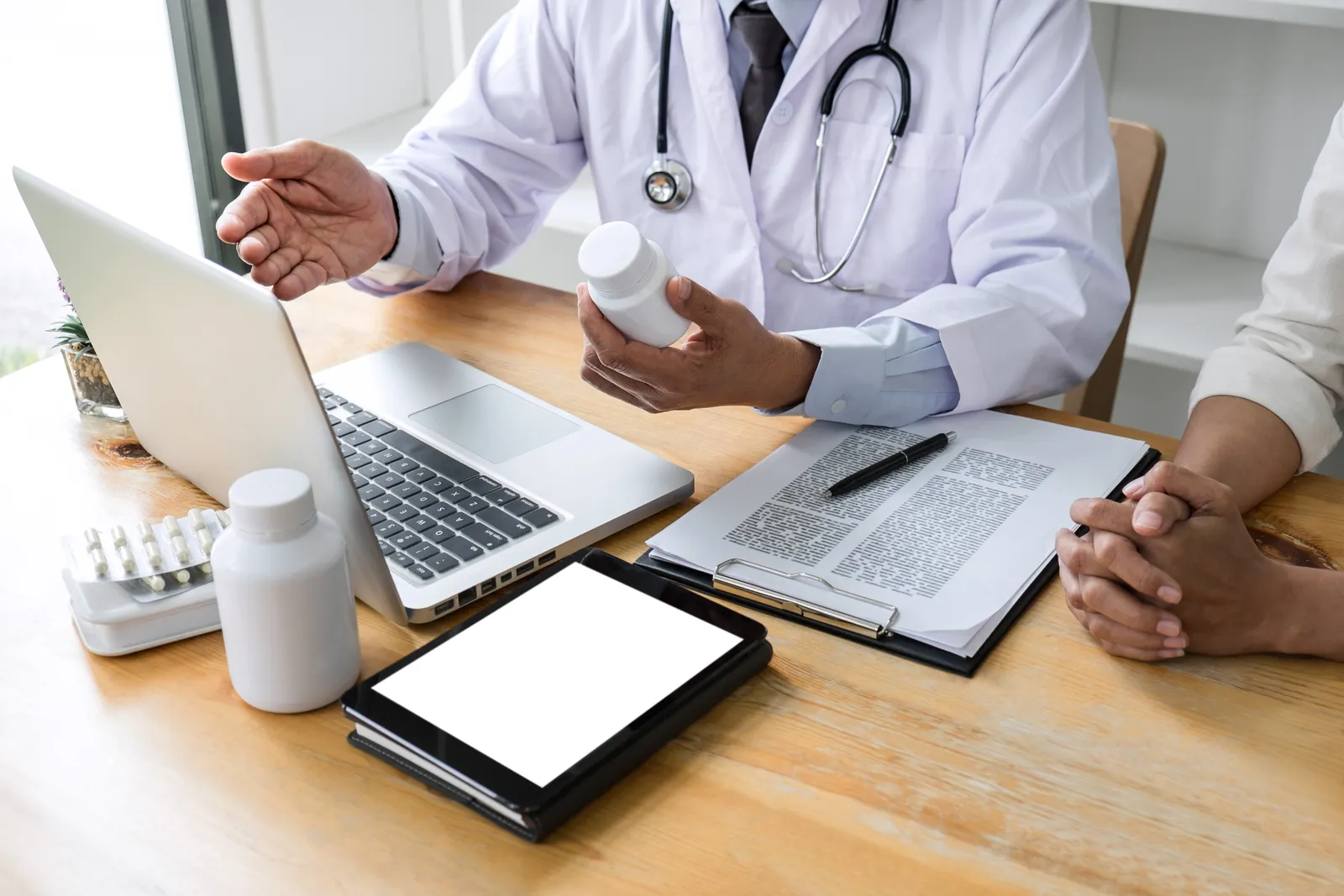Integrative medicine physician reviewing a treatment plan with a patient, blending conventional care with complementary therapies in a clinic office