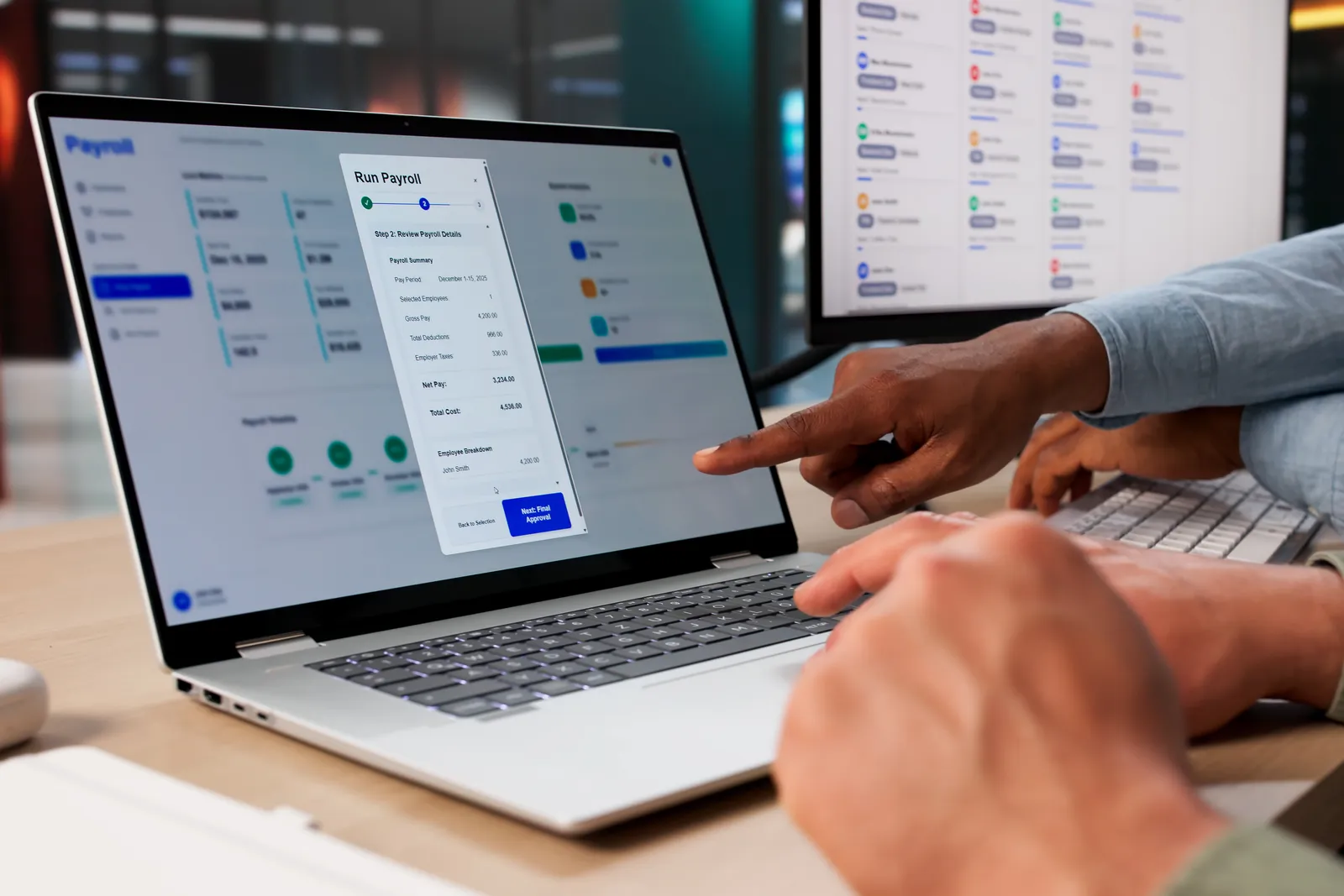 Marketplace software team reviewing vendor onboarding and order dashboards together at a laptop in their office