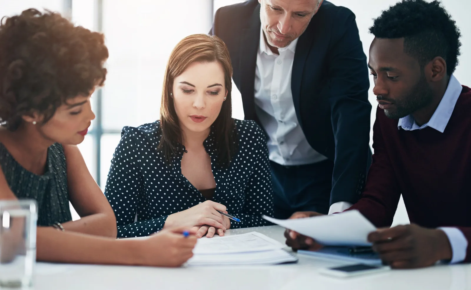 Mass tort attorneys reviewing claimant intake files around a conference table at their firm