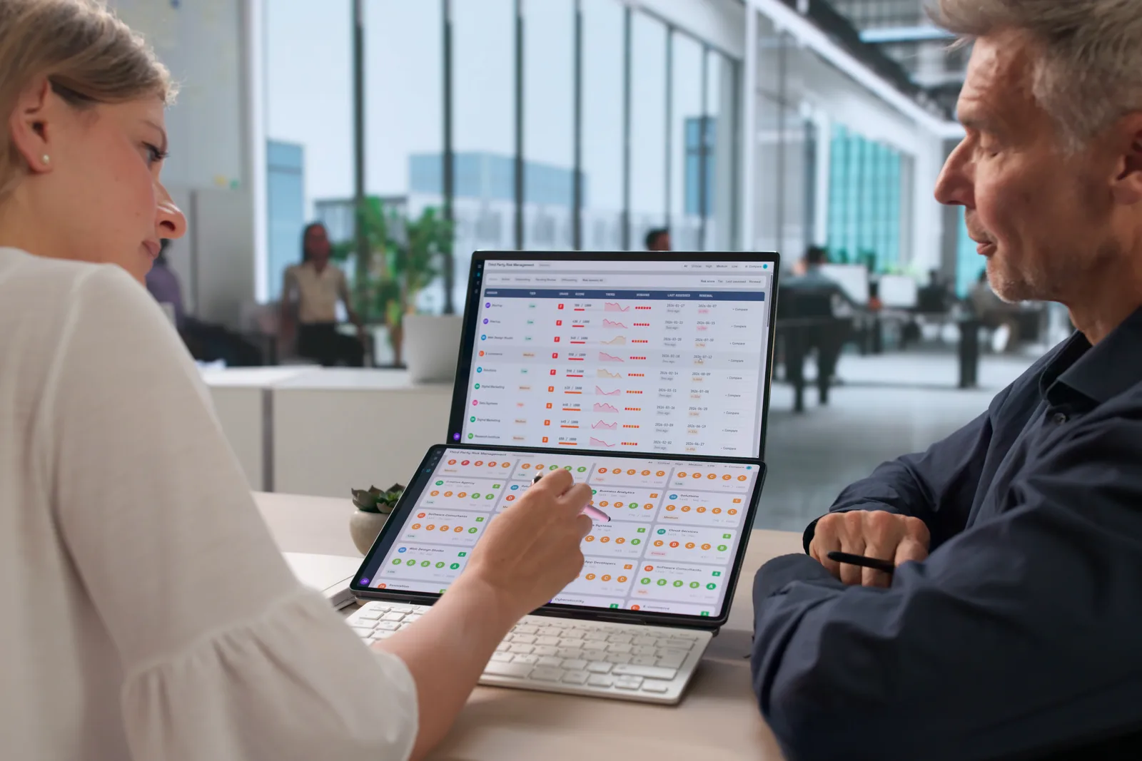 Med spa software product team reviewing patient charting and online booking dashboards together on a laptop in their office