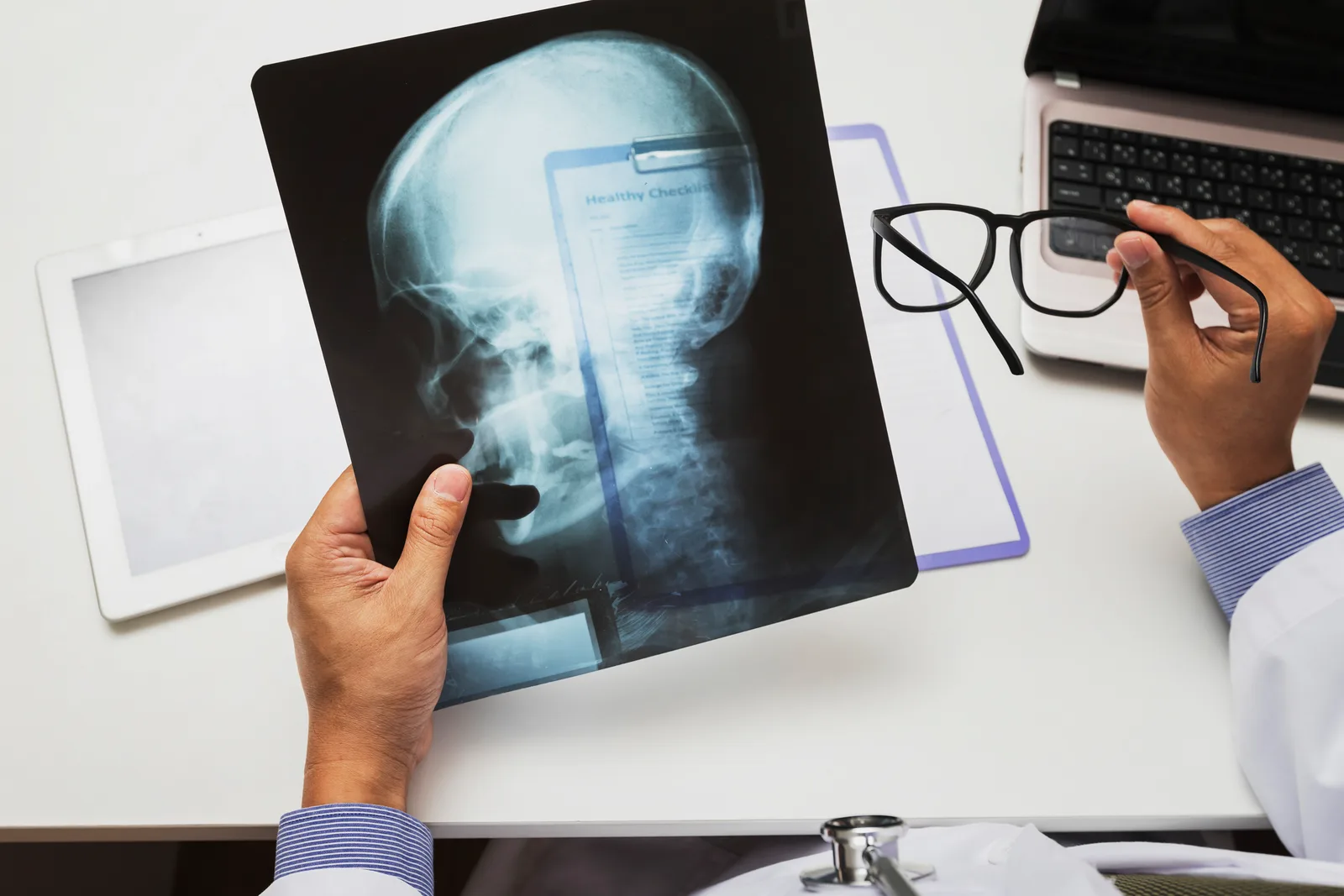Neurologist reviewing a brain MRI scan with a patient during an office consultation
