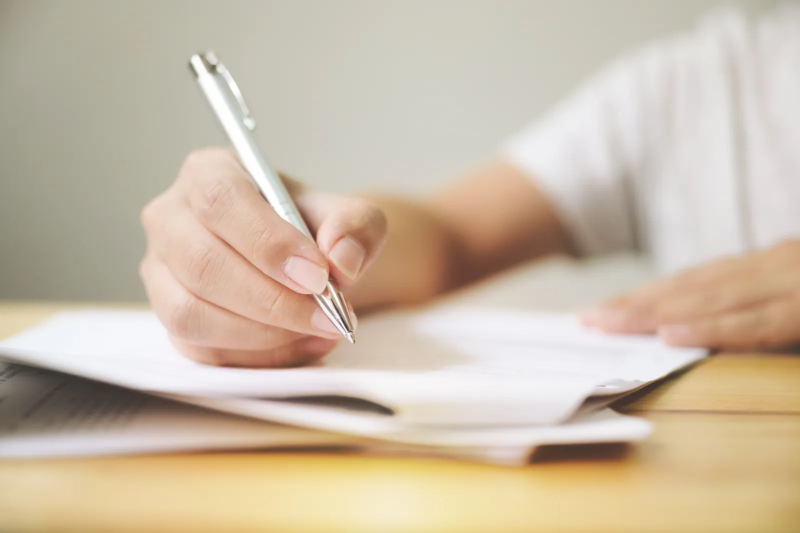 Close-up of an endorsement contract being signed at a desk
