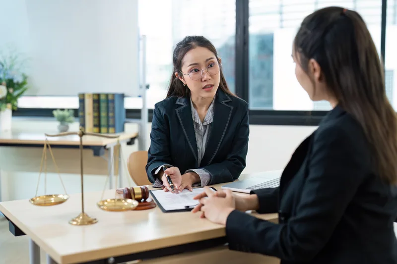 Personal injury attorney consulting with a client in a modern law office