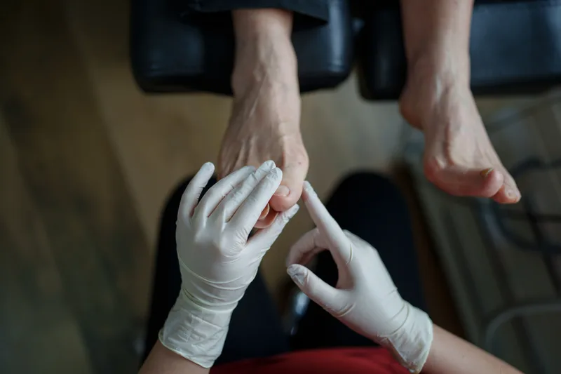 Podiatrist examining a patient's foot in a clinic