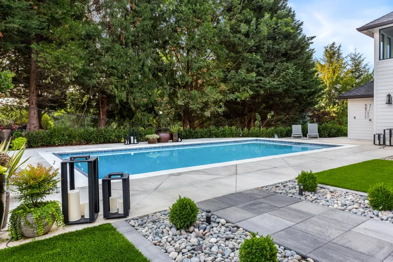 Luxury inground swimming pool in a landscaped residential backyard