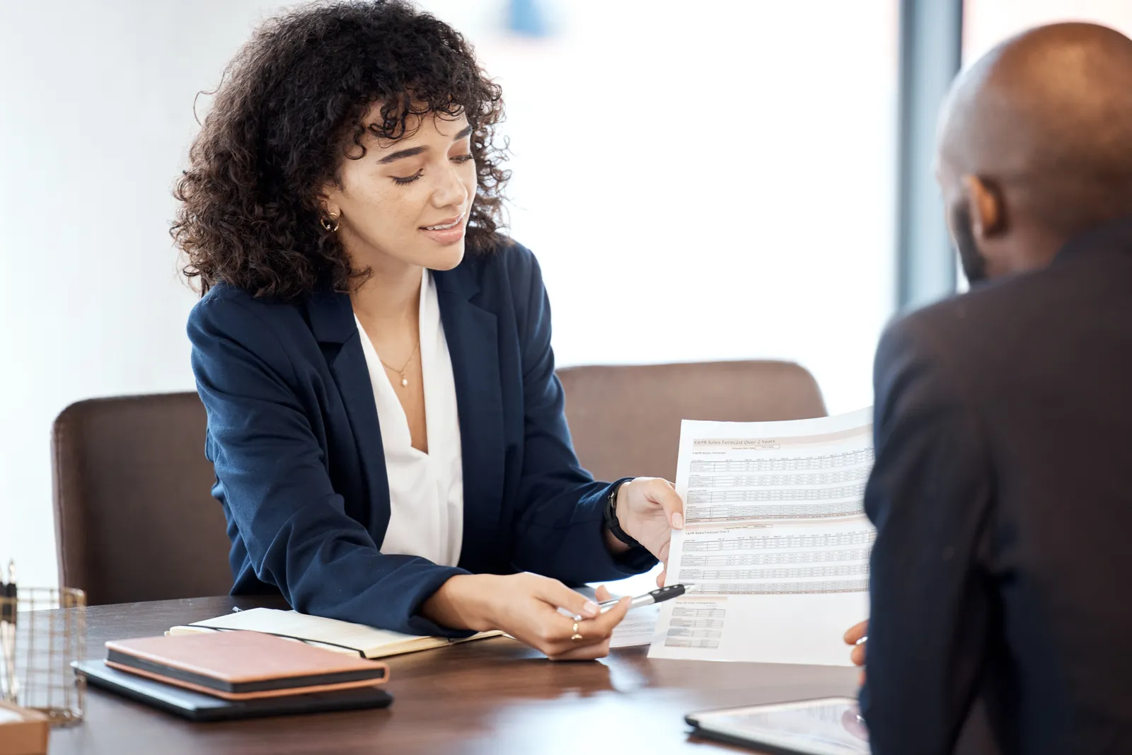 Private equity attorney reviewing a fund subscription agreement with a client across a conference table