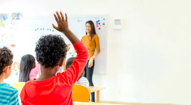 Teacher engaging students in a bright private school classroom