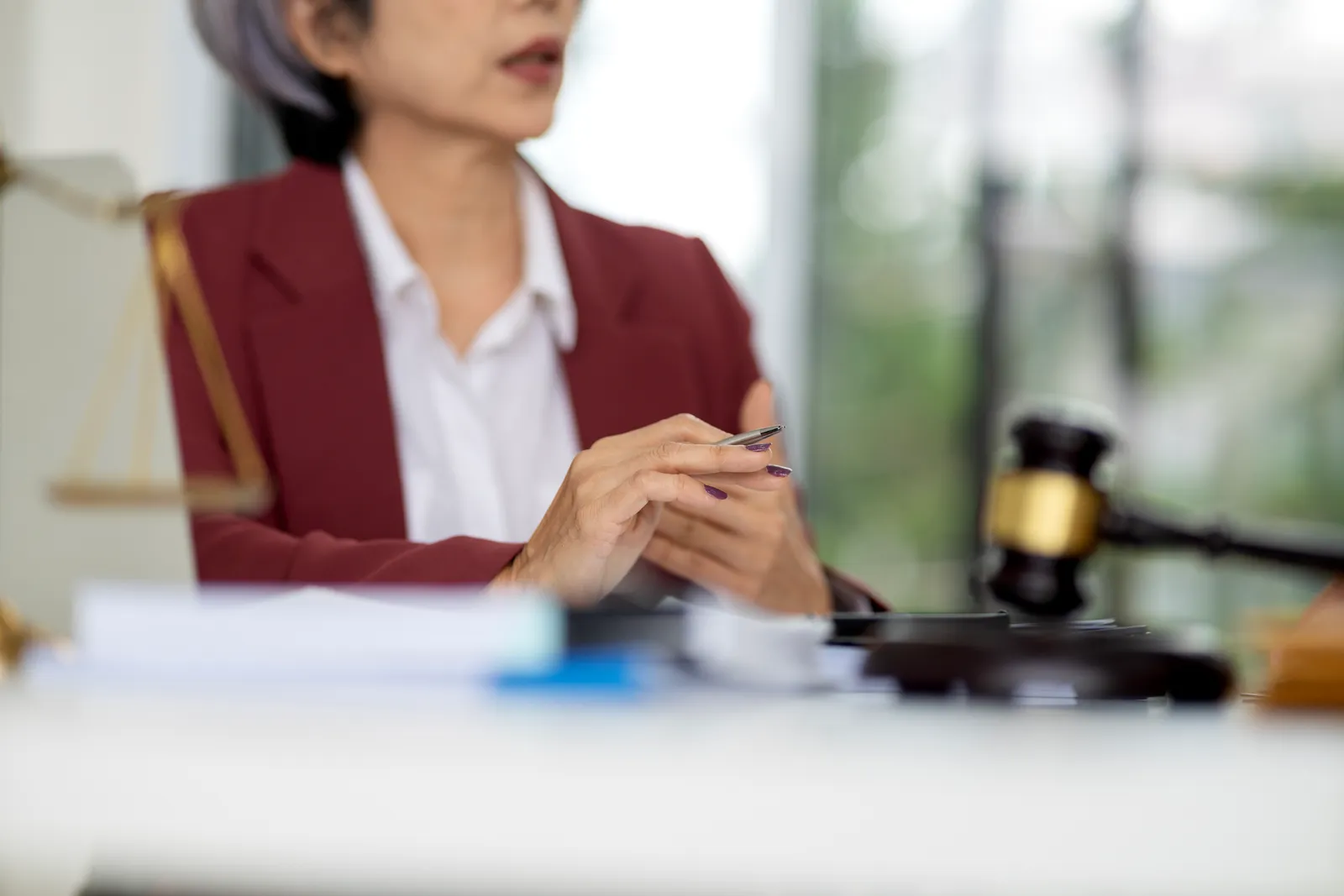Probation violation defense attorney reviewing a client's case file at his desk before a violation hearing