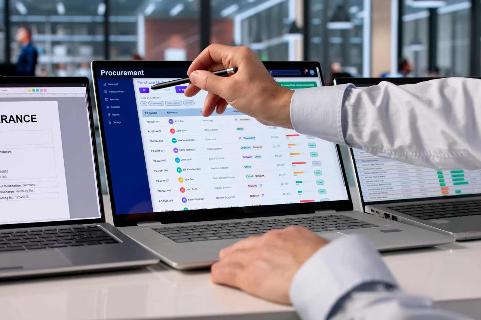 Procurement manager reviewing a purchase order approval dashboard on a laptop in an office