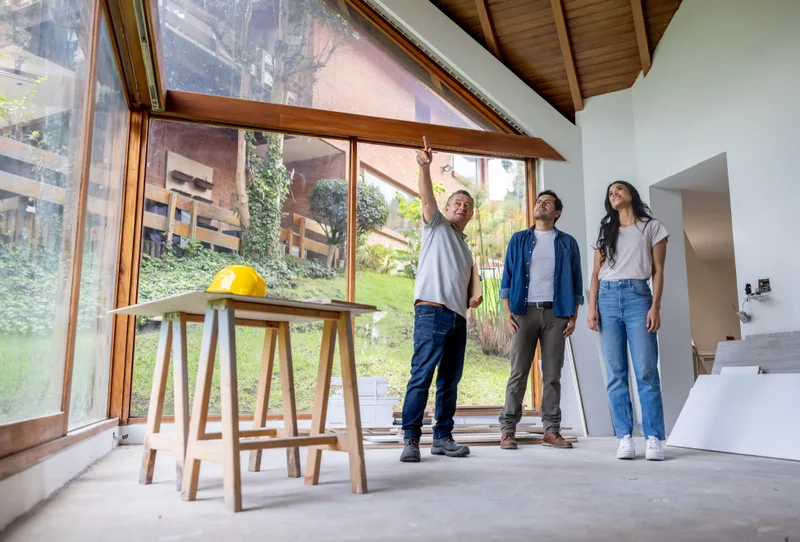 Remodeling contractor discussing renovation plans with homeowners