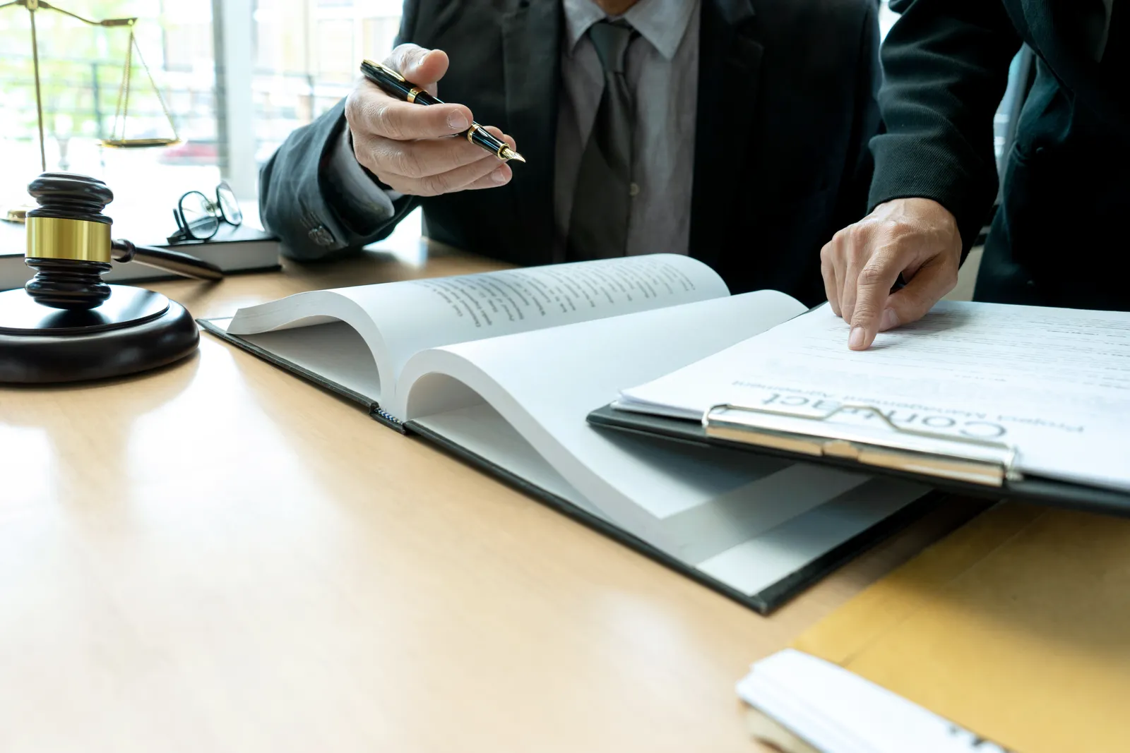 Restraining order attorney meeting with a client at his desk to review a protective order petition