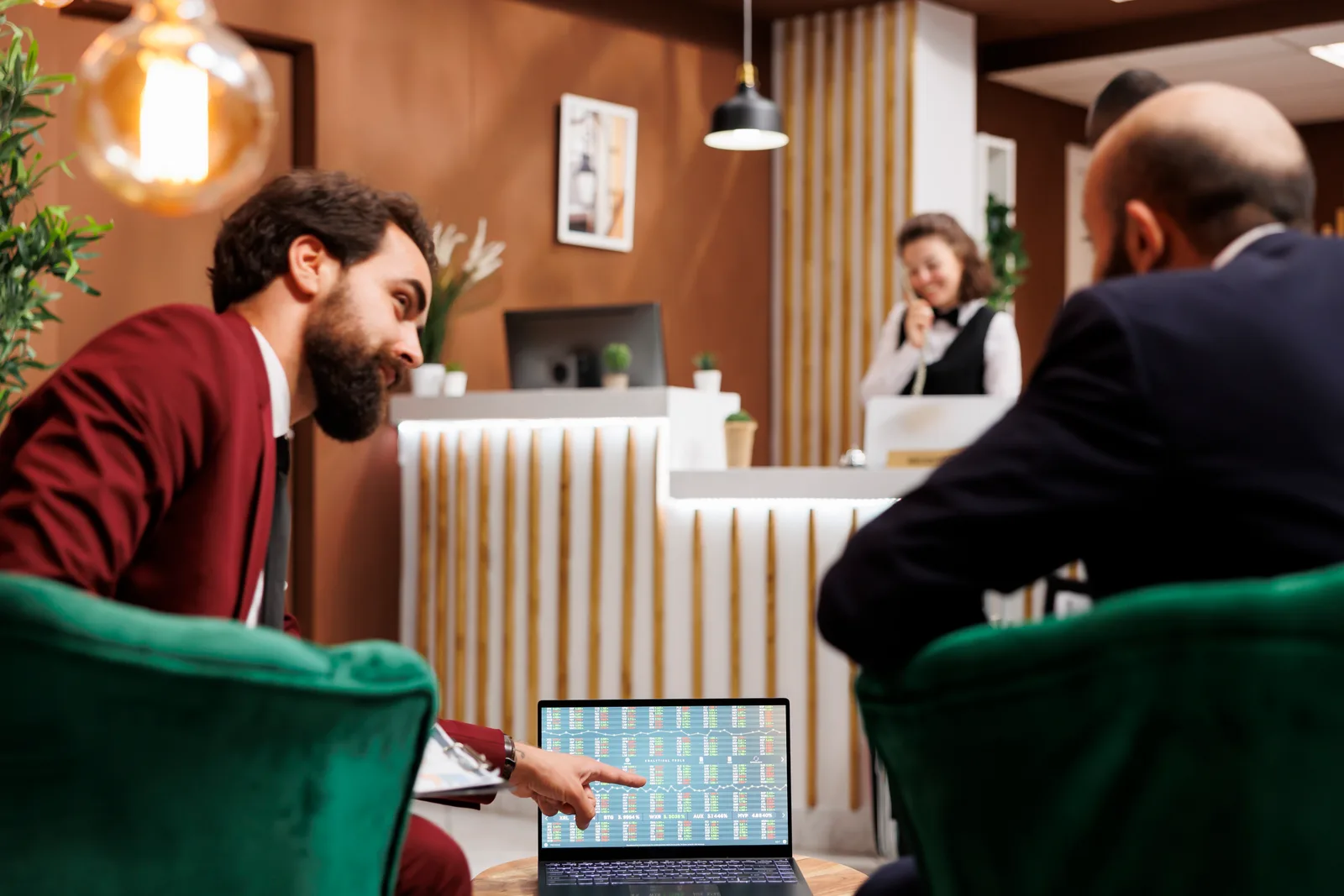 Salon and spa software product team reviewing appointment booking and staff scheduling dashboards together on a laptop in their office