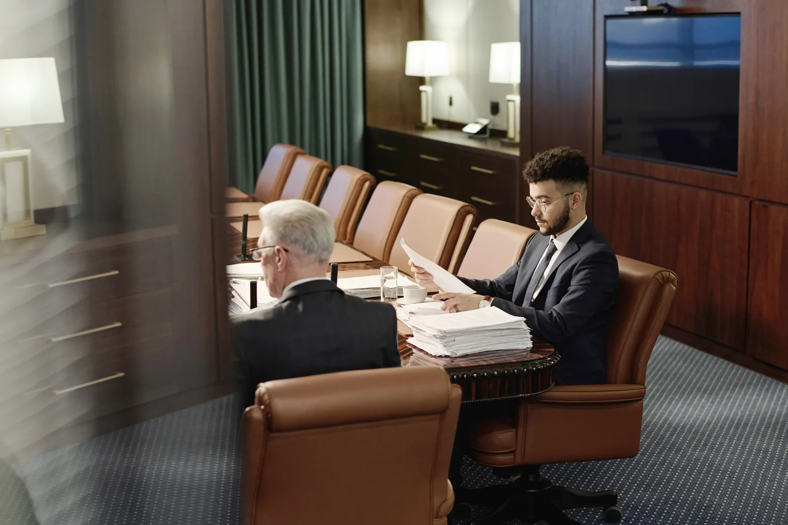 Securities attorney reviewing a private placement memorandum with a client at a conference table